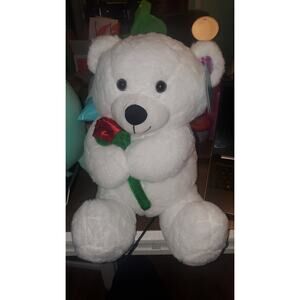 Large white teddy bear with rose